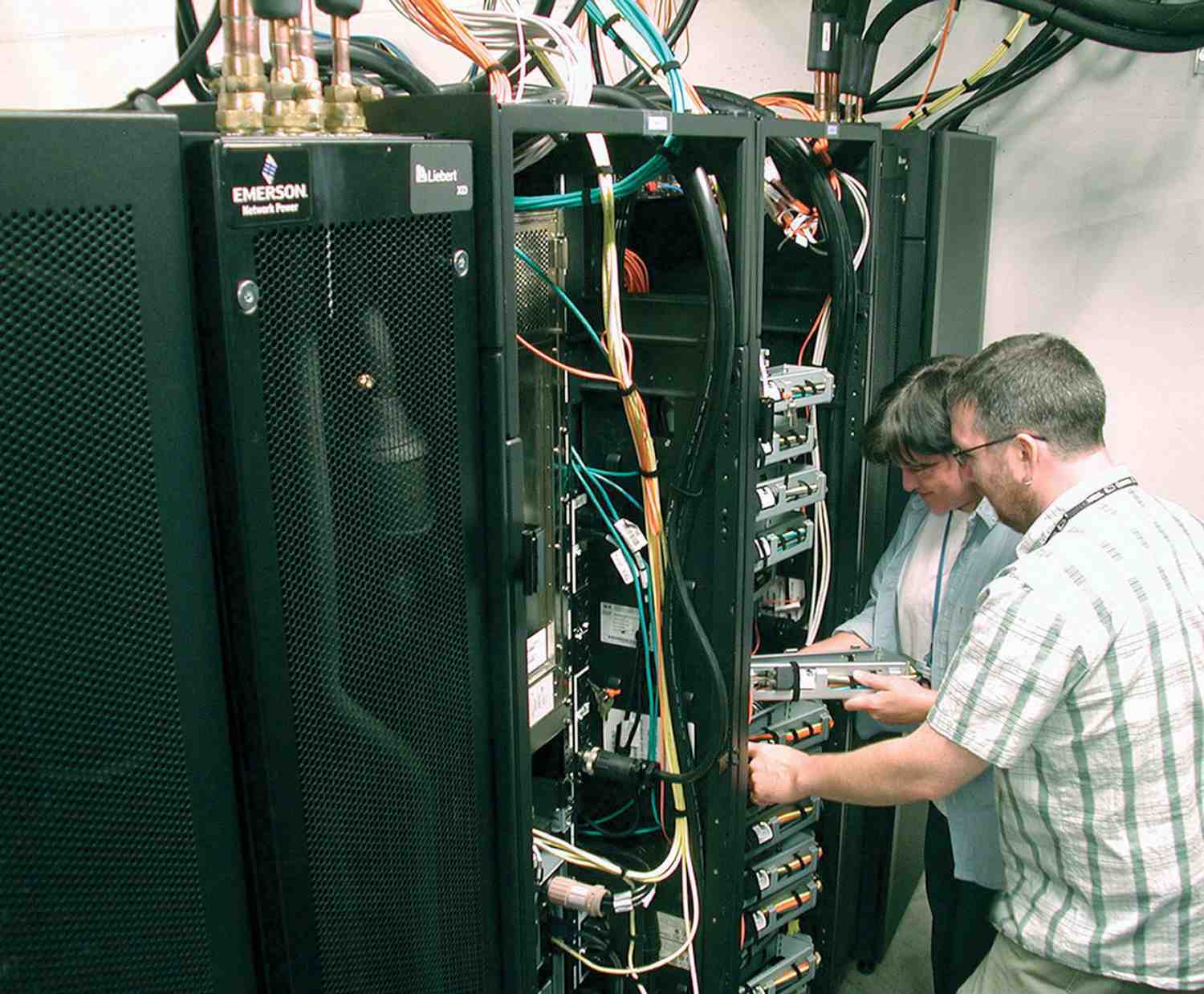Lead system administrator Denise Deatrich and network administrator Cris Payne examine the dCache servers.